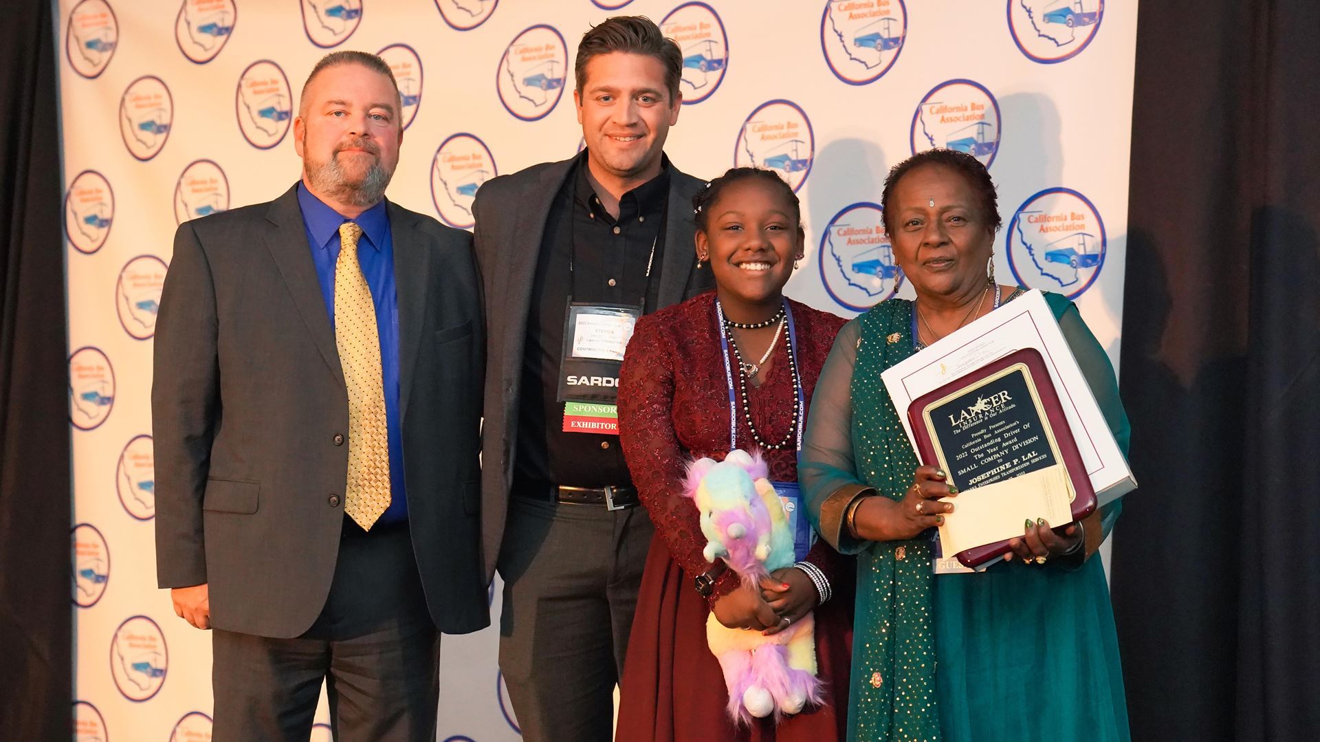 Dan Tomlinson and Steven O'Shea of Lancer Insurance, and CBA 2022 Driver of the Year, Small Operator, Josephine P. Lal of Starks Enterprises Transportation and her granddaughter, Sanaiya Anderson